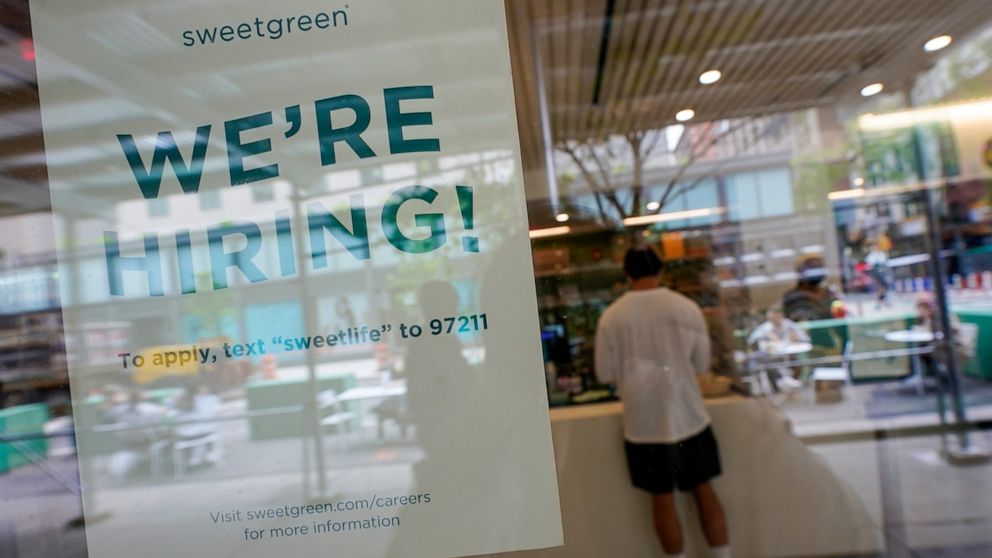 A signs announcing they are hiring hangs in the window of a restaurant in the Greenwich Village neighborhood of Manhattan in New York, Tuesday, May 4, 2021. Some restaurants in New York City are starting to hire employees now that they can increase t