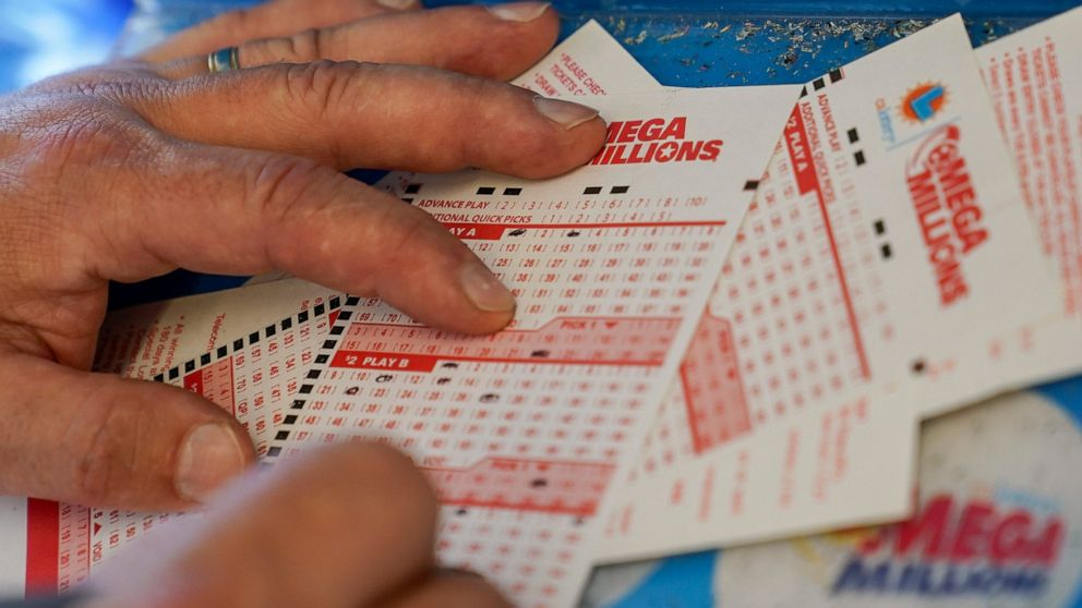 FILE - Gordon Midvale fills out a lottery ticket inside a 7-Eleven store in Oakland, Calif., July 26, 2022. Now that the Mega Millions lottery jackpot has topped $1 billion — only the fourth time a lottery game has reached such heights — plenty of pe