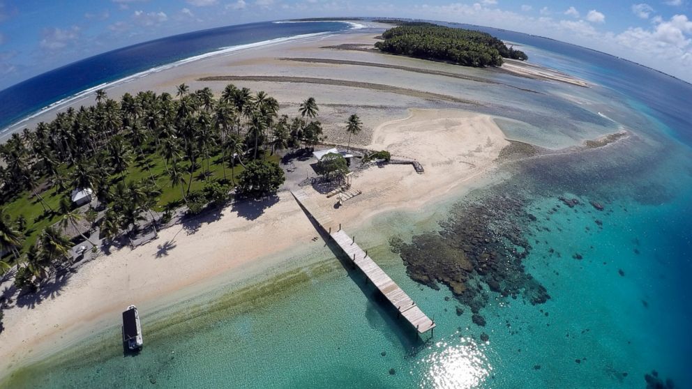 FILE - An aerial photo shows a small section of the atoll that has slipped beneath the water line only showing a small pile of rocks at low tide on Majuro Atoll in the Marshall Islands on Nov. 8, 2015. For decades, the tiny Marshall Islands has been 