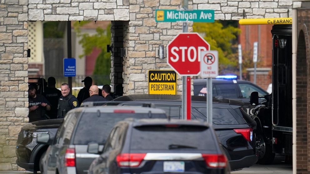Police work outside the Hampton Inn in Dearborn, Mich., is shown Thursday, Oct. 6, 2022. State police said Thursday afternoon on the department's Twitter feed that the “situation is active and dangerous” at the Hampton Inn in Dearborn and that shots 