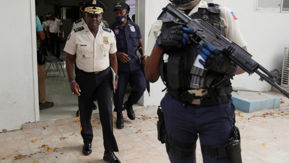 Leon Charles, left, Director General of Haiti's Police leaves a room after a news conference at police headquarters in Port-au-Prince, Wednesday, July 14, 2021. Charles gave an updated on the investigation of the July 7 assassination of President Jov