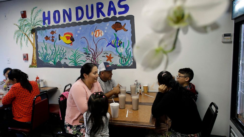 In this Thursday, June 27, 2019 photo diners eat in a Honduran-style restaurant in Chelsea, Mass. A recent study by the Pew Research Center shows the number of Central Americans in the United States increased over the last decade. Chelsea has exempli