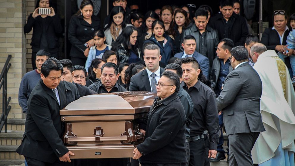 FILE - The casket of Justin Llivicura — one of four young men found slain in a suspected MS-13 gang killing, is carried from St. Joseph the Worker Church after Llivicura's funeral Wednesday, April 19, 2017, in East Patchogue, N.Y. A federal jury will