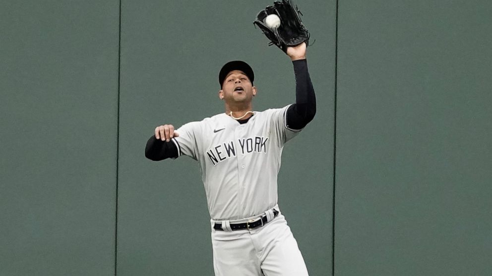New York Yankees center fielder Aaron Hicks catches a fly ball for the out on Kansas City Royals' Carlos Santana during the second inning of a baseball game Saturday, April 30, 2022, in Kansas City, Mo. (AP Photo/Charlie Riedel)