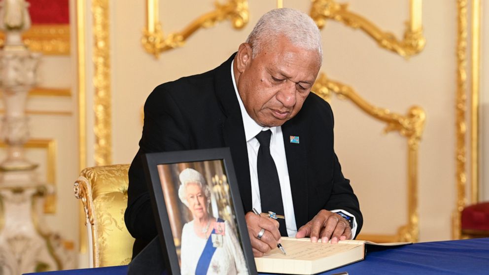 Prime Minister of Fiji, Josaia Voreqe Bainimarama signs a book of condolence at Lancaster House, London, Sunday, Sept. 18, 2022, following the death of Queen Elizabeth II. ( Jonathan Hordle/Pool Photo via AP)