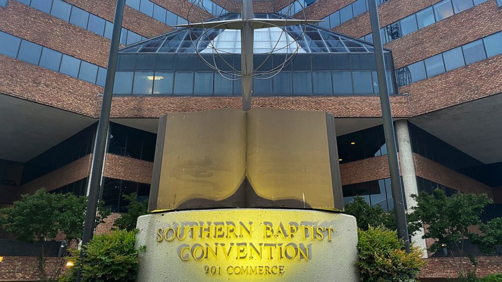 FILE - A cross and Bible sculpture stand outside the Southern Baptist Convention headquarters in Nashville, Tenn., May 24, 2022. On Tuesday, Sept. 20, 2022, the Southern Baptists' top administrative body voted to cut ties with two congregations: an L