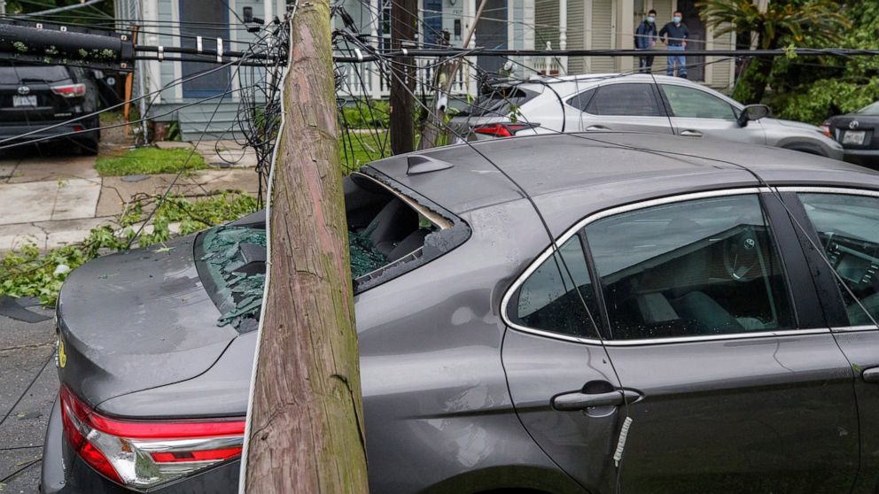 A utility pole rests on a 2020 Toyota Camry smashing the back window after powerful storms rolled through the city overnight, in New Orleans Wednesday, May 12, 2021. (David Grunfeld/The Advocate via AP)