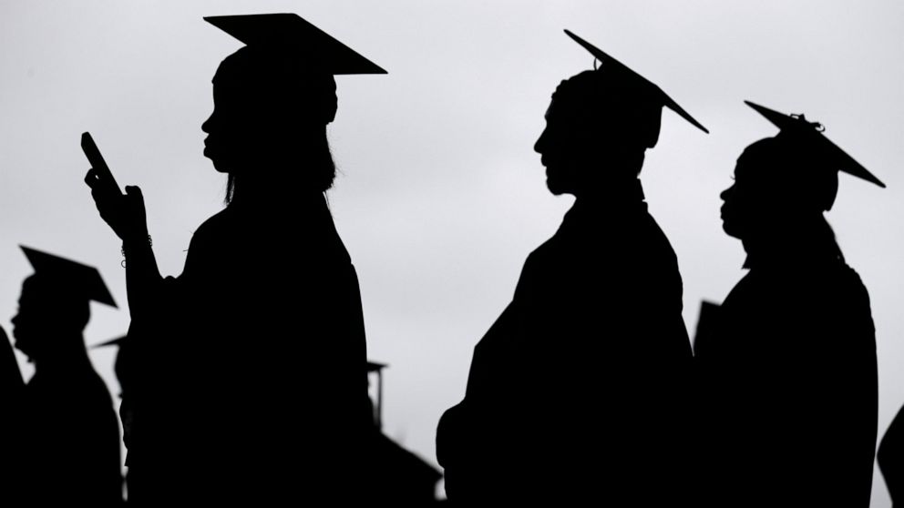 FILE - New graduates line up before the start of a community college commencement in East Rutherford, N.J., on May 17, 2018. President Joe Biden is expected to announce Wednesday Aug. 24, 2022 that many Americans can have up to $10,000 in federal stu