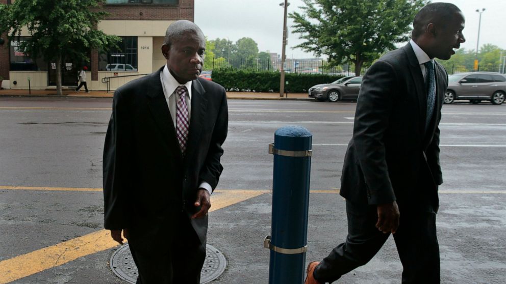 Former FBI agent William Don Tisaby, left, is accompanied by attorney Jermaine Wooten as he turns himself in at St. Louis Police headquarters on Monday, June 17, 2019, in St Louis. Tisaby has been charged in a perjury investigation related to the pro