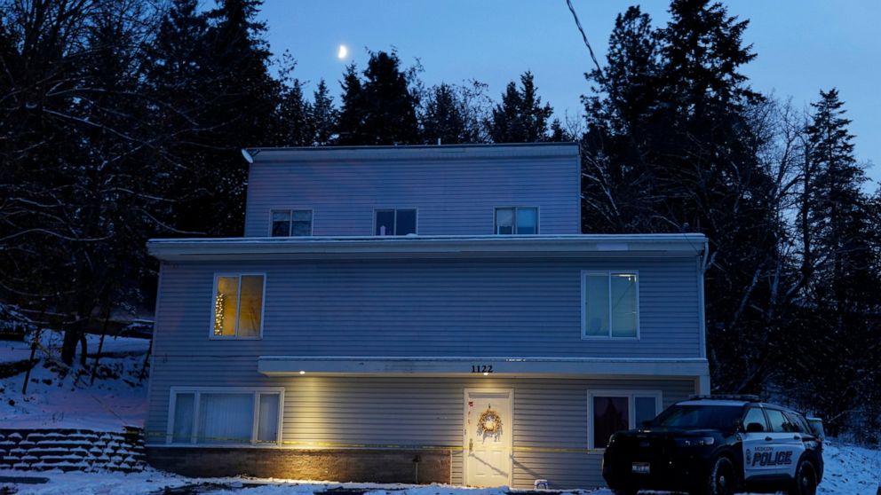 FILE - The moon rises on Nov. 29, 2022, as a Moscow police officer stands guard in his vehicle at the home where four University of Idaho students were found dead on Nov. 13, 2022 in Moscow, Idaho. It's been nearly three weeks since four University o