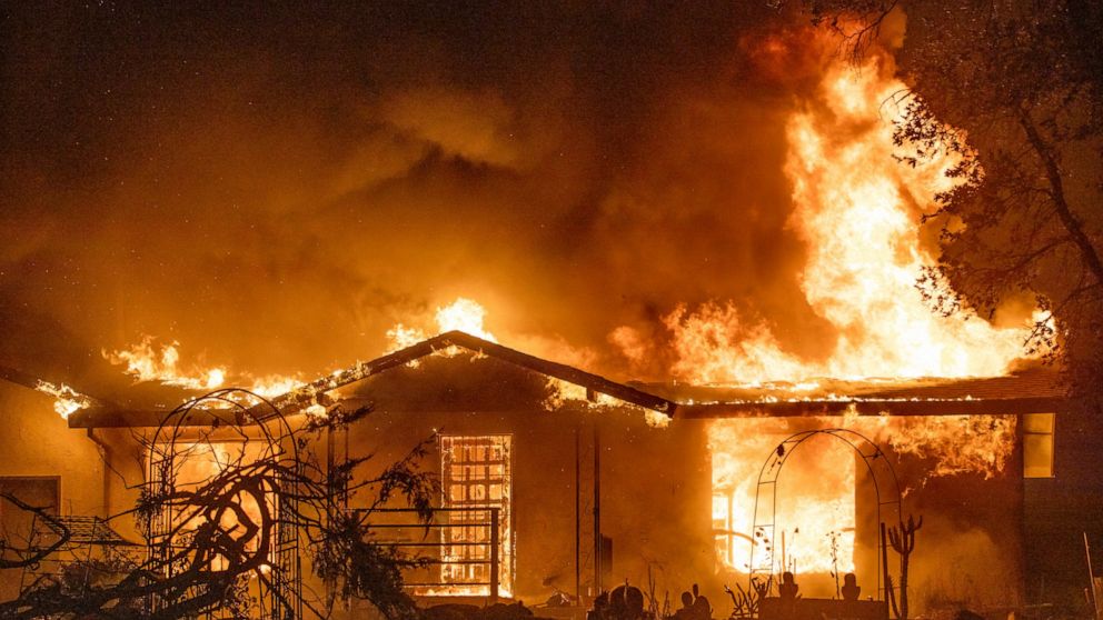 FILE - In this Sept. 27, 2020, file photo, a house burns on Platina Road at the Zogg Fire near Ono, Calif. Pacific Gas & Electric has been charged with manslaughter and other crimes, Friday, Sept. 24, 2021, in a Northern California wildfire last year