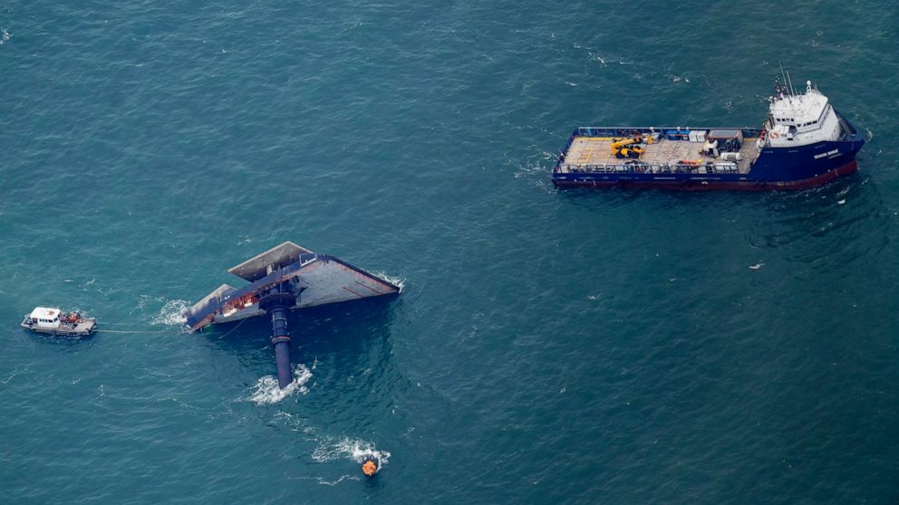 Rescue boats are seen next to the capsized lift boat Seacor Power seven miles off the coast of Louisiana in the Gulf of Mexico Sunday, April 18, 2021. The vessel capsized during a storm on Tuesday. (AP Photo/Gerald Herbert)