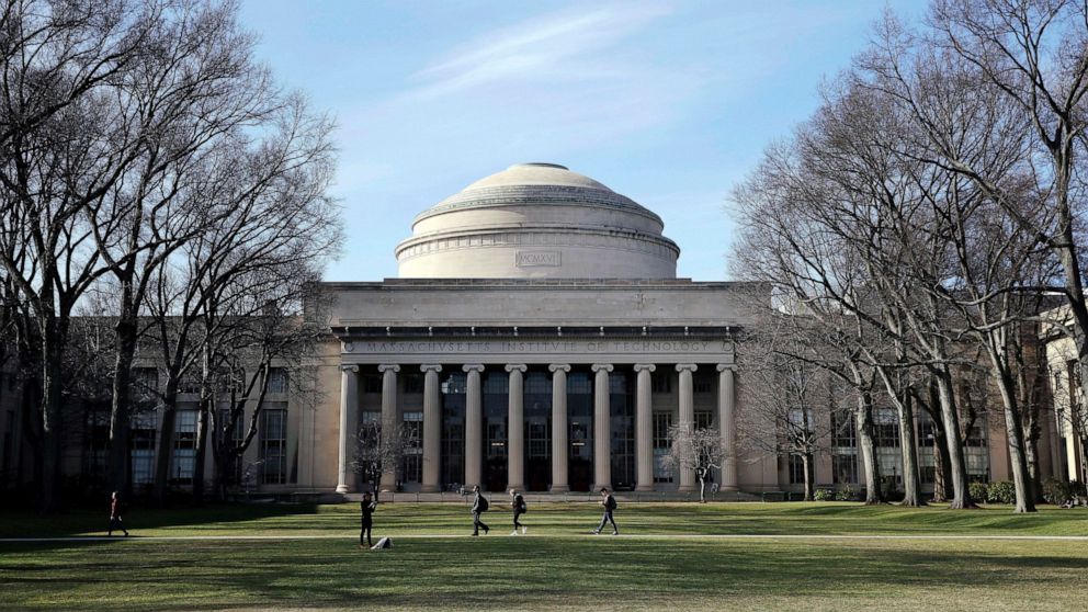 FILE - In this April 3, 2017 file photo, students walk past the "Great Dome" atop Building 10 on the Massachusetts Institute of Technology campus in Cambridge, Mass. MIT said Media Lab director Joi Ito resigned Saturday, Sept. 7, 2019, after reports 