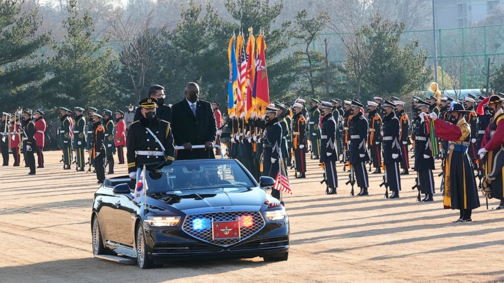 U.S. Defense Secretary Lloyd Austin, standing right on a car, and South Korean Defense Minister Suh Wook inspect a guard of honor during a welcoming ceremony at the Defense Ministry in Seoul, South Korea, Thursday, Dec. 2, 2021. (AP Photo/Ahn Young-j