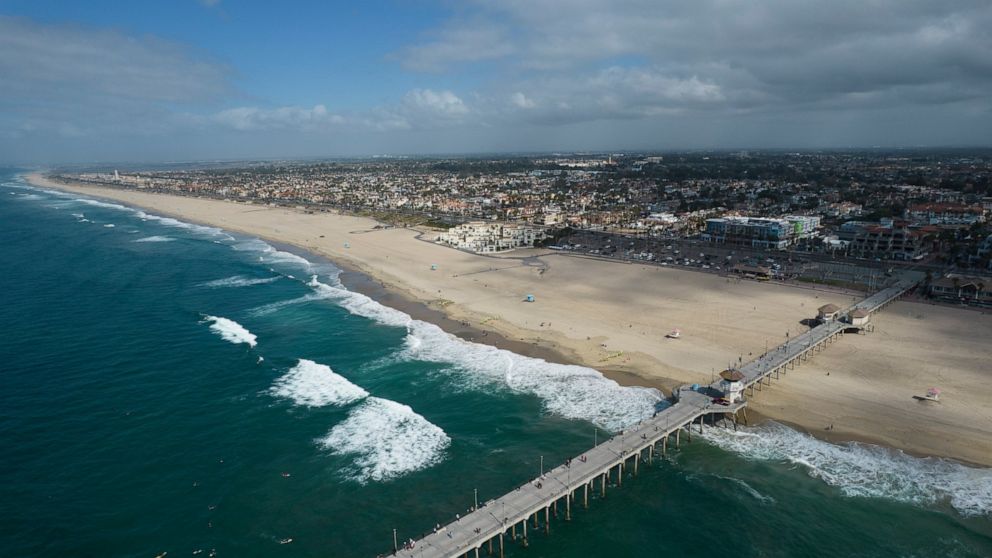 FILE - This aerial photo shows the pier and shoreline in Huntington Beach, Calif., on Oct. 11, 2021. A coyote attacked and injured a girl on Southern California's famed Huntington Beach. A police spokesperson says the attack occurred Thursday, April 