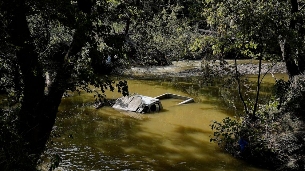 FILE - A truck is sunk in water after massive flooding in Hindman, Ky., Aug. 2, 2022. Kentucky Gov. Andy Beshear complained Thursday, Aug. 11, 2022, that the Federal Emergency Management Agency is denying too many requests for assistance in flood-rav