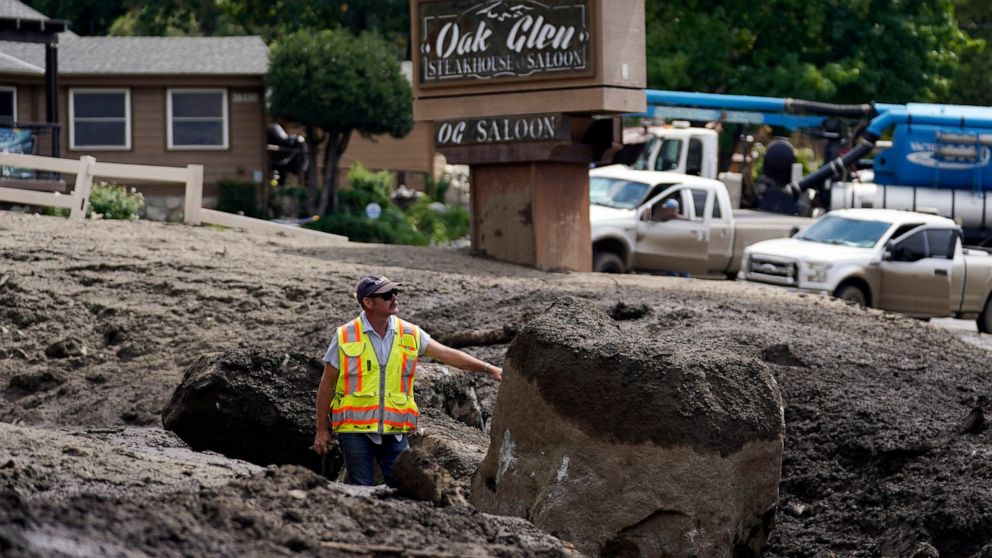 Paul Burgess, with the California Geological Survey, examines the damage in the aftermath of a mudslide Tuesday, Sept. 13, 2022, in Oak Glen, Calif. Cleanup efforts and damage assessments are underway east of Los Angeles after heavy rains unleashed m