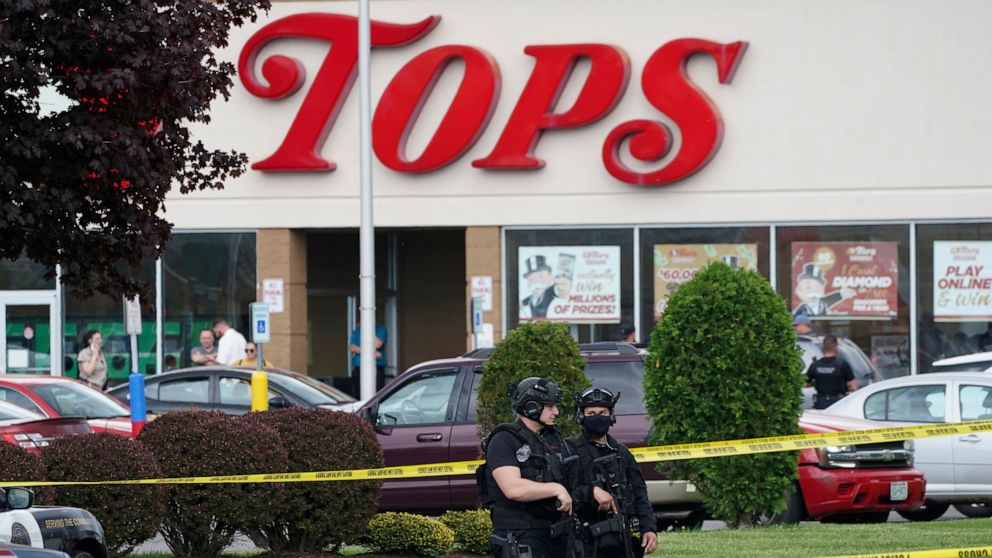 FILE - Police secure an area around a supermarket where several people were killed in a shooting, Saturday, May 14, 2022, in Buffalo, N.Y. New York’s new law barring sales of bullet-resistant vests to most civilians doesn't cover the type of armor wo
