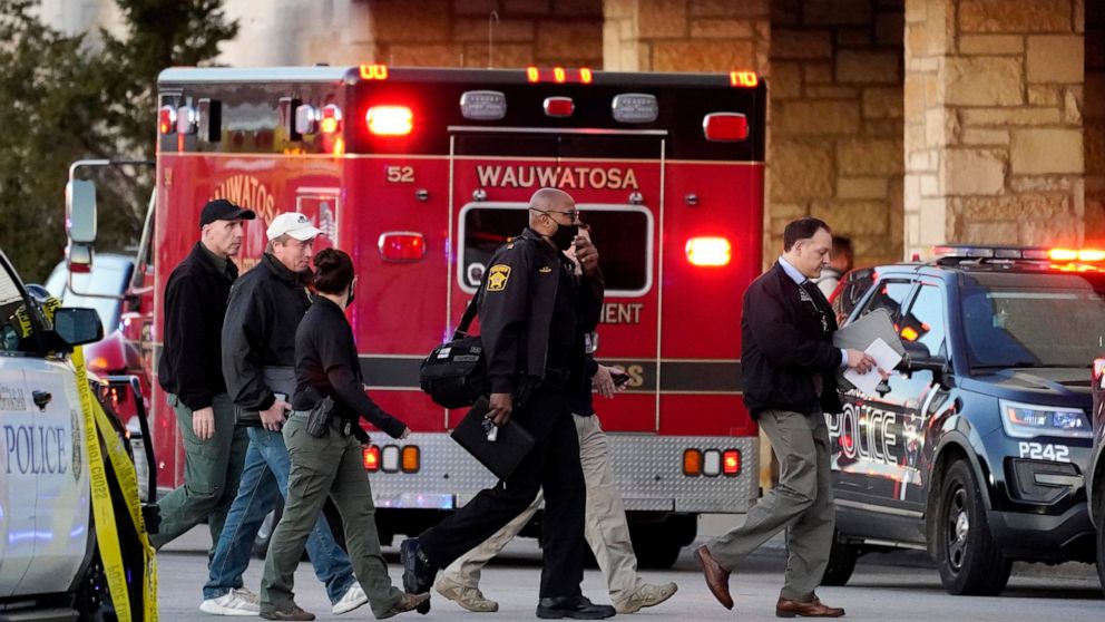 Police officials walk to the Mayfair Mall, Friday, Nov. 20, 2020, in Wauwatosa, Wis. Multiple people were shot Friday afternoon at the mall and police are still searching for the shooter. (AP Photo/Nam Y. Huh)