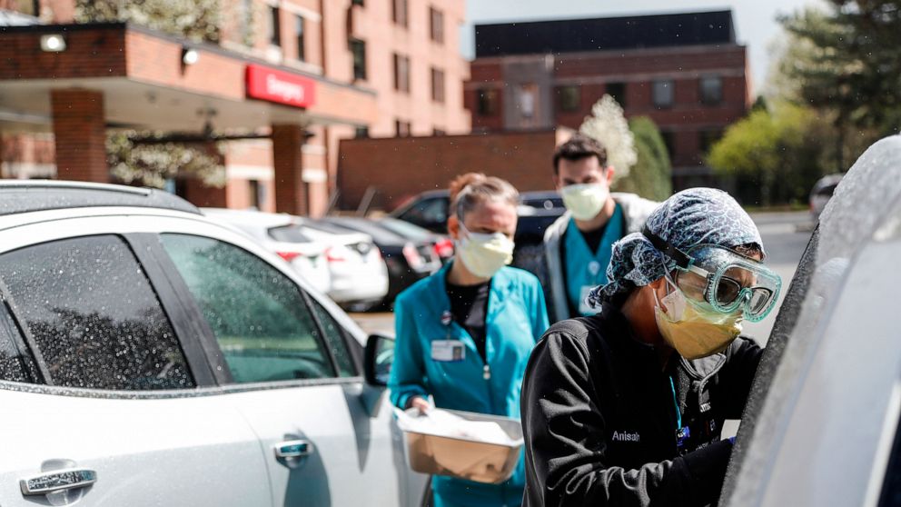 FILE - In this April 15, 2021, file photo, Emergency Room technicians test patients for Covid-19 outside of the emergency entrance of Beaumont Hospital in Grosse Pointe, Mich. Michigan has become the current national hotspot for COVID-19 infections a