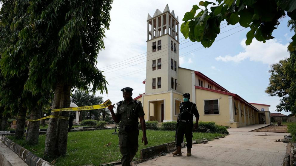 Nigerian police officers tape around the St. Francis Catholic church in Owo Nigeria, Monday, June 6, 2022 a day after an attack that targeted worshipers. The gunmen who killed 50 people at a Catholic church in southwestern Nigeria opened fire on wors