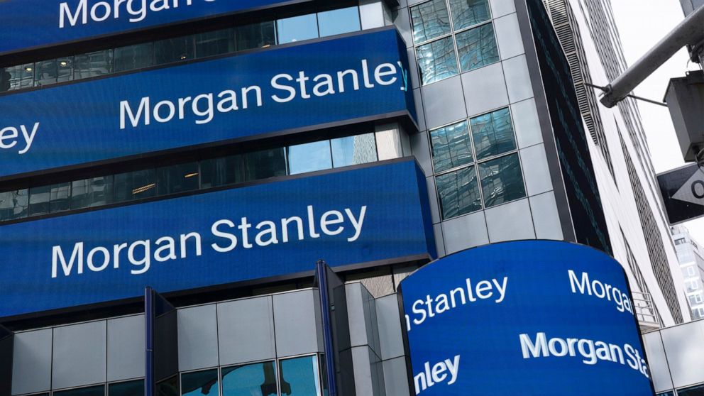 FILE - In this Thursday, March 4, 2021, file photo, electronic signage is shown at Morgan Stanley headquarters, in New York. Wall Street’s big investment banks are sending a message to their employees this summer: Get back into the office, and bring 