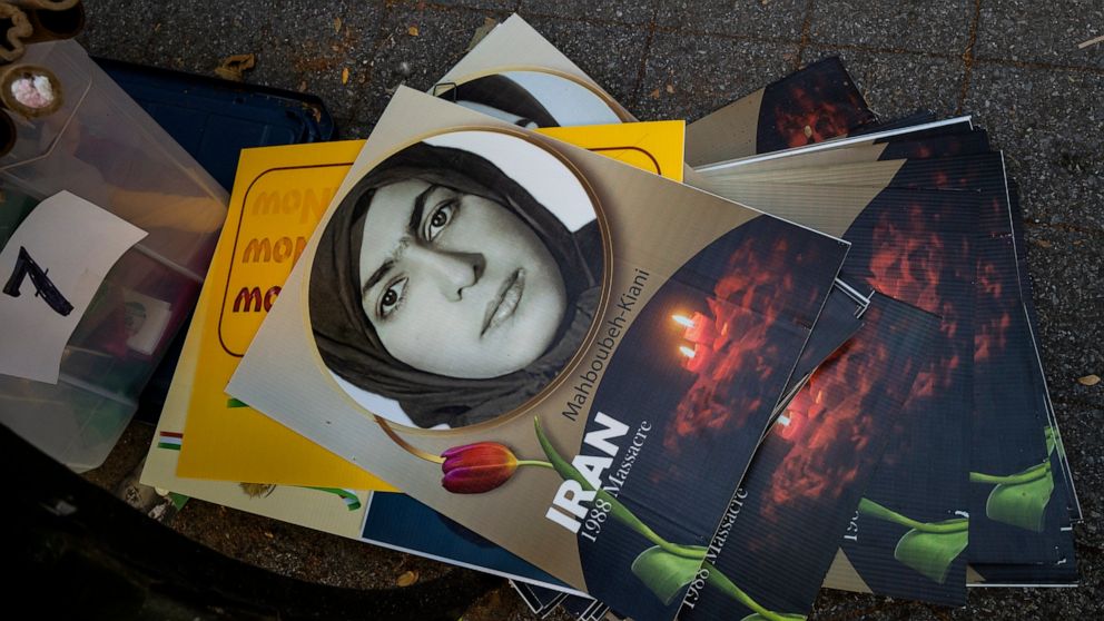 Placards used in a protest lay stacked on the ground in the midst of Iranian Americans and others during a rally near the United Nations Wednesday, Sept. 21, 2022, in New York, as protesters came together to demand the prosecution of the President of