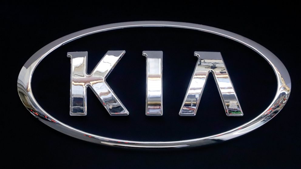 FILE - In this Feb. 14, 2019 file photo, the KIA logo is displayed on a sign at the 2019 Pittsburgh International Auto Show in Pittsburgh. Kia is telling owners of nearly 380,000 vehicles in the U.S. to park them outdoors due to the risk of an engine