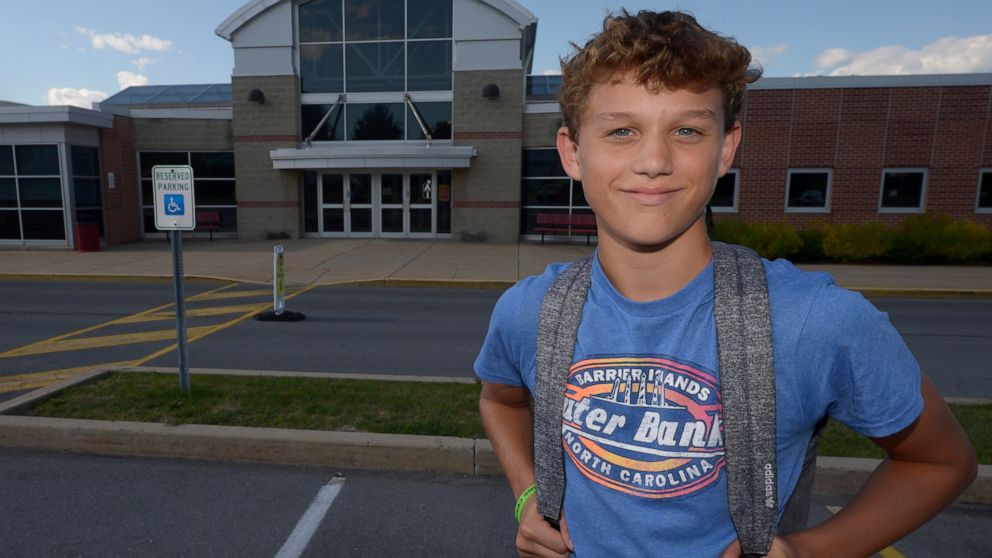 Braylon Price, 13, pauses on his way home from Bellefonte Middle School Wednesday, Aug. 31, 2022, in Bellefonte, Pa. The teenager was among more than 45,000 Pennsylvania students whose parents elected to take advantage of a new state pandemic-era law