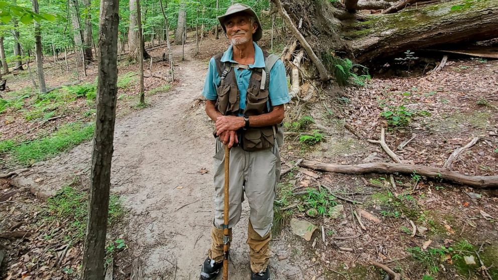 In this photo provided by Joe Villari, with the Virginia Outdoors Foundation, William H. “Marty” Martin poses for a picture at the Bull Run Mountains Preserve in Broad Run, Va., in July 2021. Martin, a respected snake researcher who had been making s