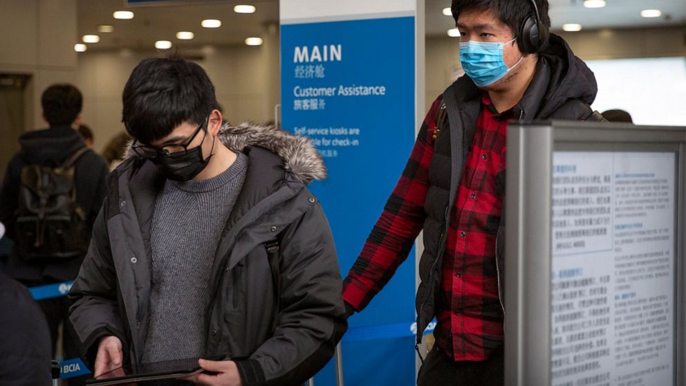 Fever alarms, paranoia as masked passengers fly from China thumbnail