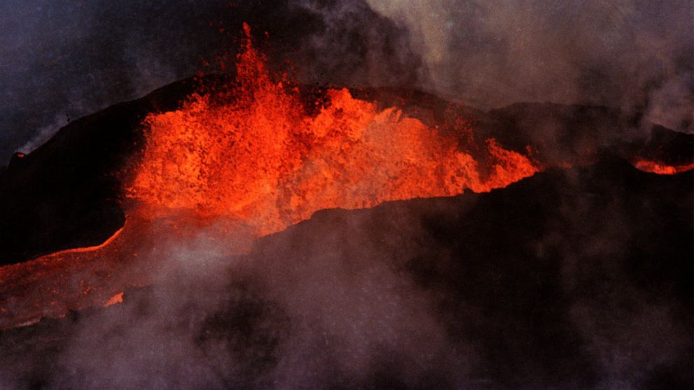 FILE - Molten rock flows from Mauna Loa on March 28, 1984, near Hilo, Hawaii. Hawaii officials are warning residents of the Big Island to prepare for the possibility that the world's largest active volcano may erupt given a recent spike in earthquake