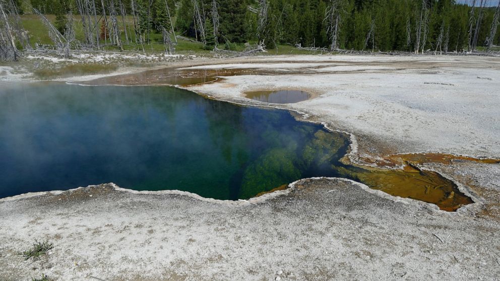 In this photo provided by the National Park Service is the Abyss Pool hot spring in the southern part of Yellowstone National Park, Wy., in June 2015. Park officials are investigating after part of a foot, in a shoe, was found floating in the hot spr