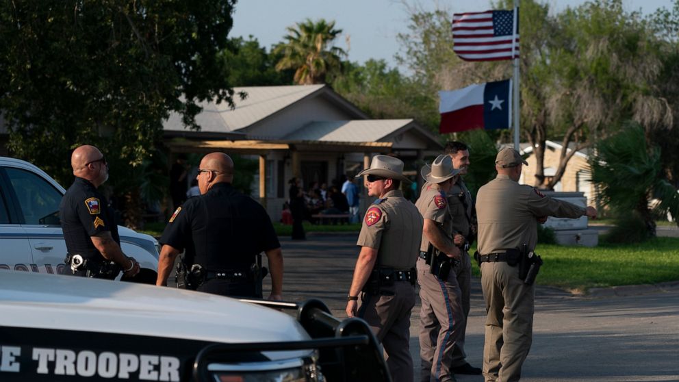 Law enforcement personnel stand outside a funeral home during a visitation for Amerie Garza, a 10-year-old victim who was killed in last week's elementary school shooting in Uvalde, Texas, Monday, May 30, 2022. (AP Photo/Jae C. Hong)