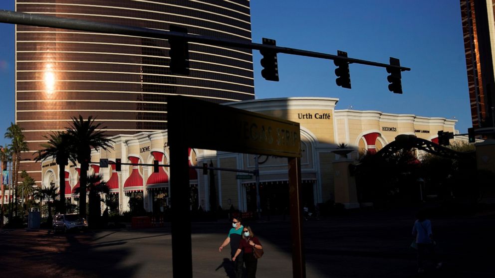 FILE - People cross Las Vegas Boulevard near the Wynn Las Vegas in Las Vegas. An effort by Nevada casino regulators to impose a $500,000 fine and discipline former Las Vegas casino mogul Steve Wynn over allegations of workplace sexual misconduct had 