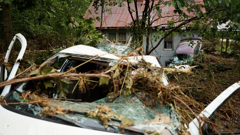 Damaged vehicles rest under debris, Thursday, July 14, 2022 in Whitewood, Va., following a flash flood. Virginia Gov. Glenn Youngkin declared a state of emergency to aid in the rescue and recovery efforts from Tuesday's floodwaters. (AP Photo/Michael