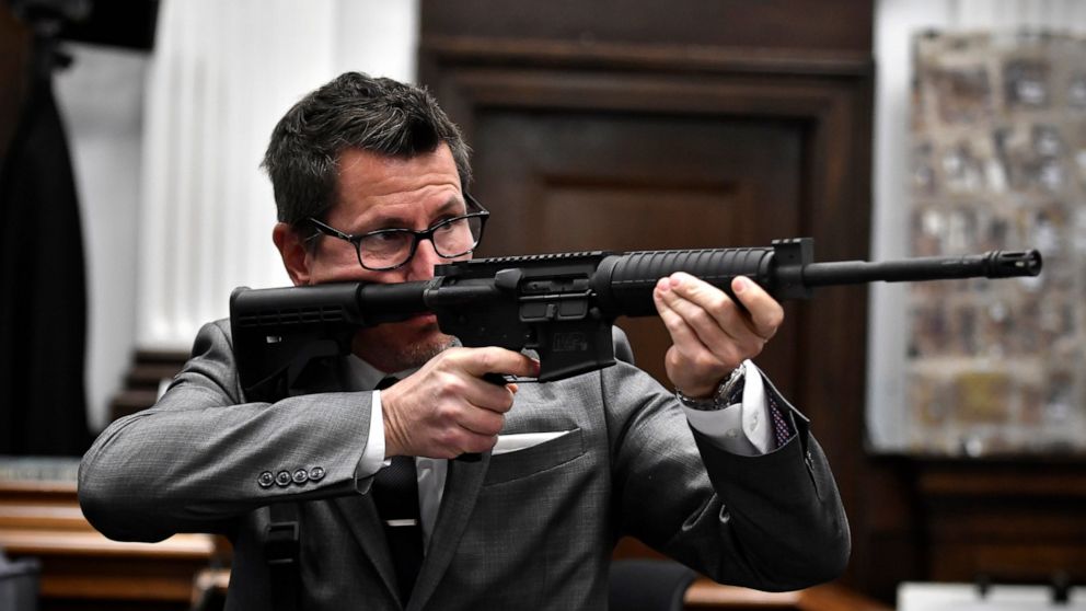 Assistant District Attorney Thomas Binger holds Kyle Rittenhouse's gun as he gives the state's closing argument in Kyle Rittenhouse's trial at the Kenosha County Courthouse in Kenosha, Wis., on Monday, Nov. 15, 2021. Rittenhouse is accused of killing