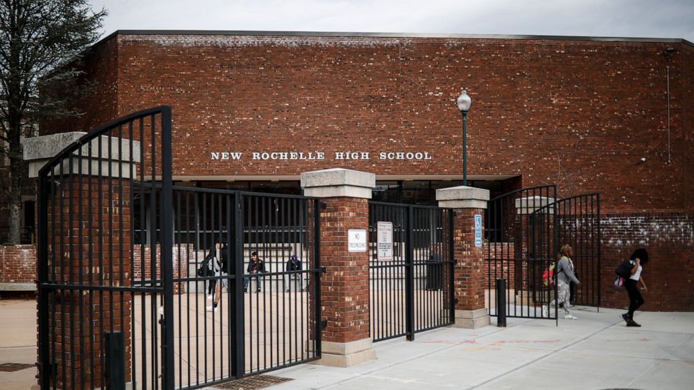 Students leave New Rochelle High School after classes are dismissed, Tuesday, March 10, 2020, in New York. State officials are shuttering schools and houses of worship for two weeks in part of the New York City suburb New Rochelle and sending the Nat