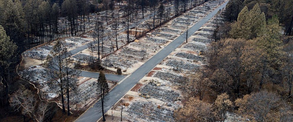 FILE- In this Dec. 3, 2018, file photo, homes leveled by the Camp Fire line the Ridgewood Mobile Home Park retirement community in Paradise, Calif. New figures released by California Gov. Gavin Newsom show the town of Paradise lost over 90% of its po