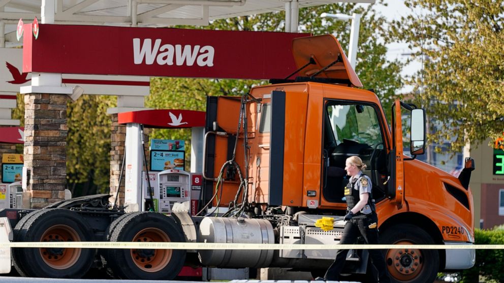 An investigator works the crime scene at a Wawa convenience store and gas station in Breinigsville, Pa., Wednesday, April 21, 2021. Police on Wednesday converged on a convenience store in eastern Pennsylvania following what state police called a "ser