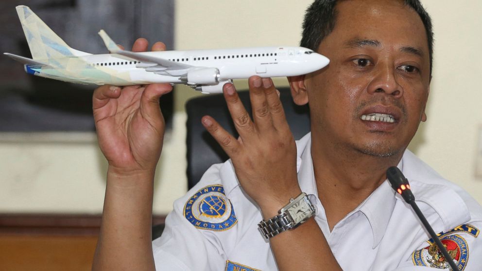 FILE - In this Nov. 28, 2018, file photo, National Transportation Safety Committee investigator Nurcahyo Utomo holds a model of an airplane during a press conference on the committee's preliminary findings on their investigation on the crash of Lion 
