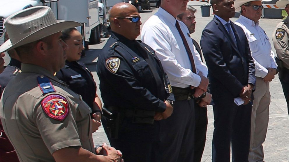 FILE - Uvalde School Police Chief Pete Arredondo, third from left, stands during a news conference outside of the Robb Elementary school in Uvalde, Texas, on May 26, 2022. As public pressure mounts for more information on the deadly Uvalde school sho