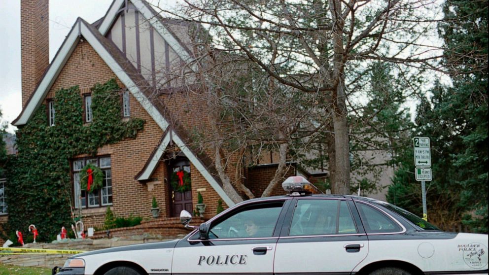 FILE - In this Jan. 3, 1997, file photo, a police officer sits in her cruiser outside the home in which 6-year-old JonBenet Ramsey was found murdered in Boulder, Colorado on Dec. 26, 1996. The father of JonBenet Ramsey, John Ramsey, is supporting an 