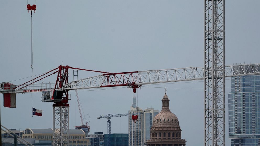 Construction cranes hover over downtown and near the State Capitol, Monday, April 26, 2021, in Austin, Texas. Texas' torrid growth over the past decade is paying off with a major boost in political clout. (AP Photo/Eric Gay)