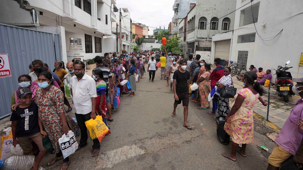 FILE - Sri Lankans queue up near a fuel station to buy kerosene in Colombo, Sri Lanka, Tuesday, April 12, 2022. When the Federal Reserve raises interest rates -- as it did Wednesday, May 4, 2022 -- the impact doesn’t stop with U.S. homebuyers paying 
