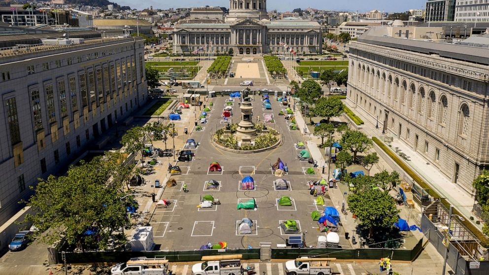 FILE - In this May 21, 2020, file photo, rectangles designed to help prevent the spread of the coronavirus by encouraging social distancing line a city-sanctioned homeless encampment at San Francisco's Civic Center. California has spent $13 billion i