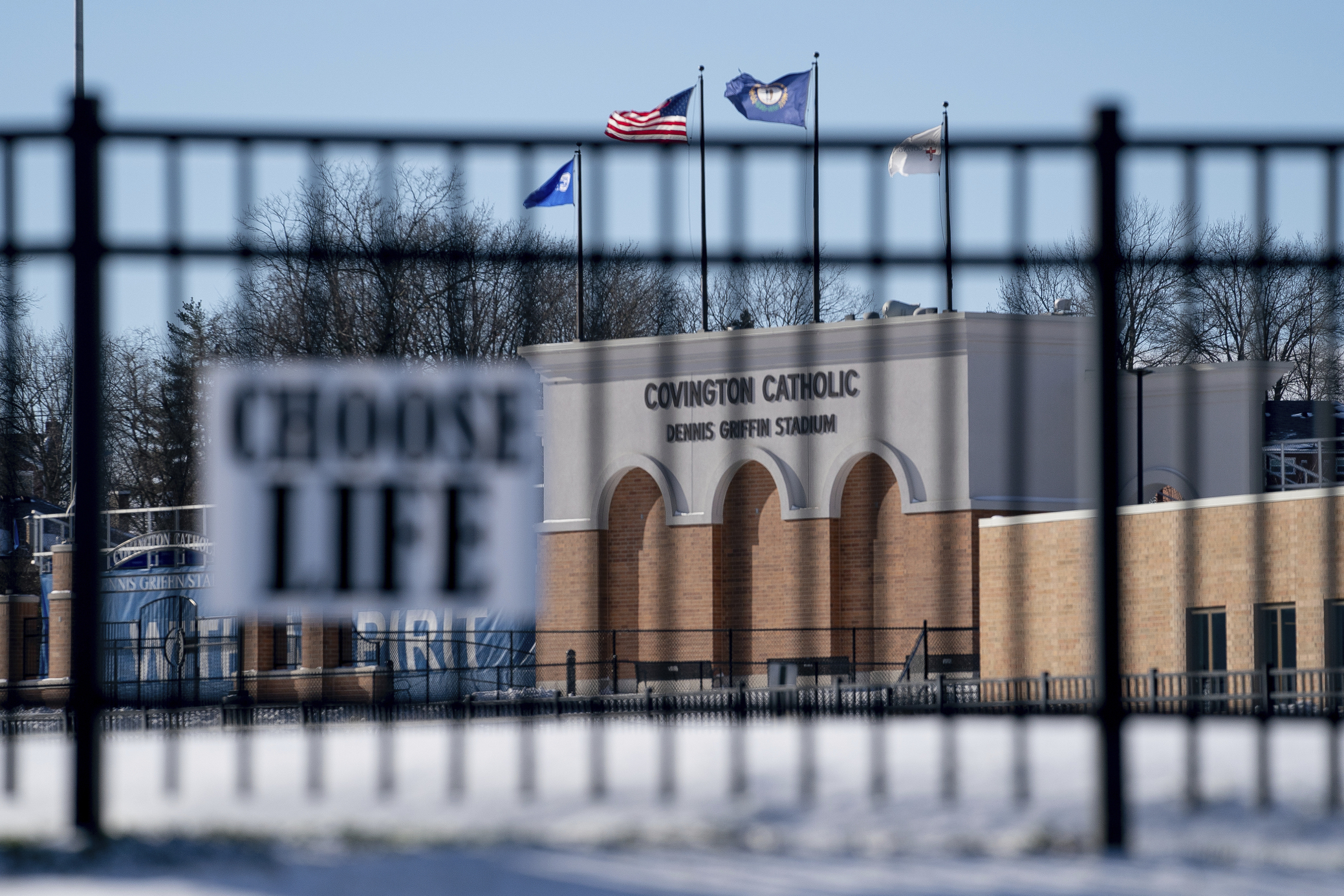 Flags fly over the Covington Catholic High School stadium in Park Kills, Ky., Sunday, Jan 20, 2019. A diocese in Kentucky has apologized after videos emerged showing students from the Catholic boys' high school mocking Native Americans outside the Li