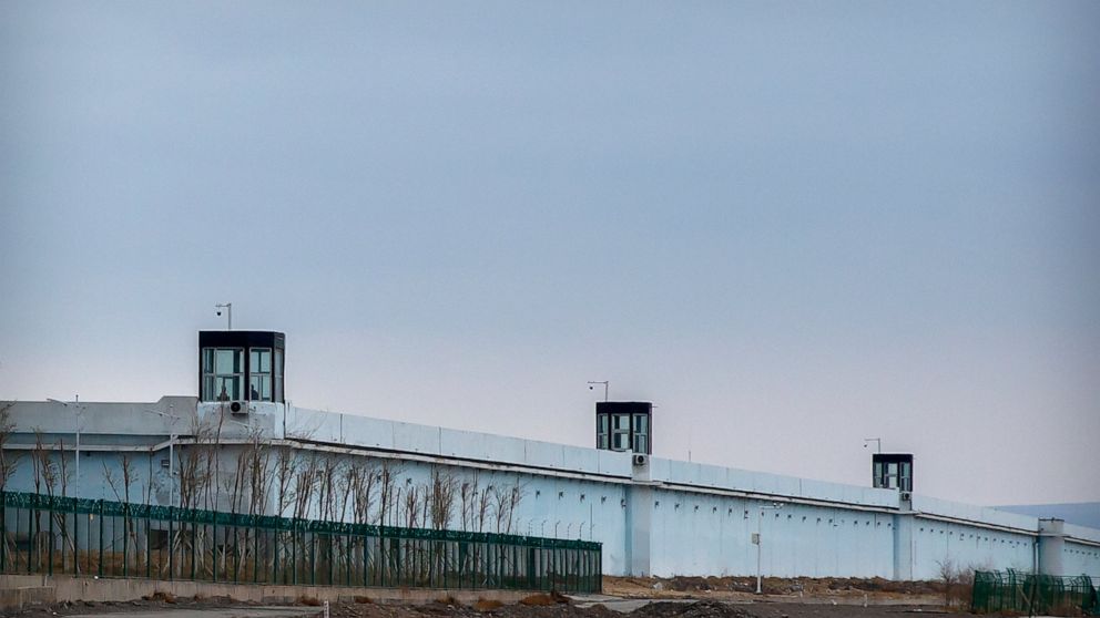 FILE - People stand in a guard tower on the perimeter wall of the Urumqi No. 3 Detention Center in Dabancheng in western China's Xinjiang Uyghur Autonomous Region on April 23, 2021. After a U.N. report concluding that China's crackdown in the far wes
