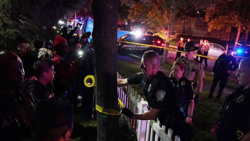 Police put up tape in an area near an officer involved shooting on East 77th Street in Richfield, Minn., Saturday night, Sept. 7, 2019. Police near Minneapolis shot and killed a driver following a chase after he apparently emerged from his car holdin