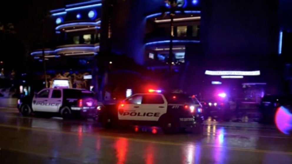 In this image made from video, police vehicles park outside the scene of a restaurant shooting Thursday, July 8, 2021, in Houston, Texas. Two men were killed and a woman was wounded in what Houston police say was a murder-suicide at a downtown seafoo